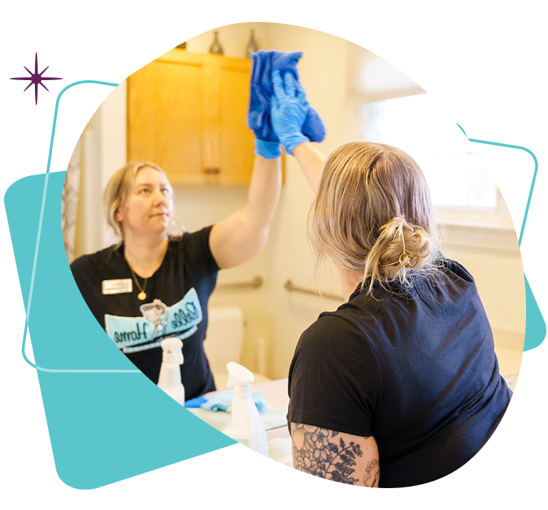 Two Belle Home cleaners working together in a kitchen